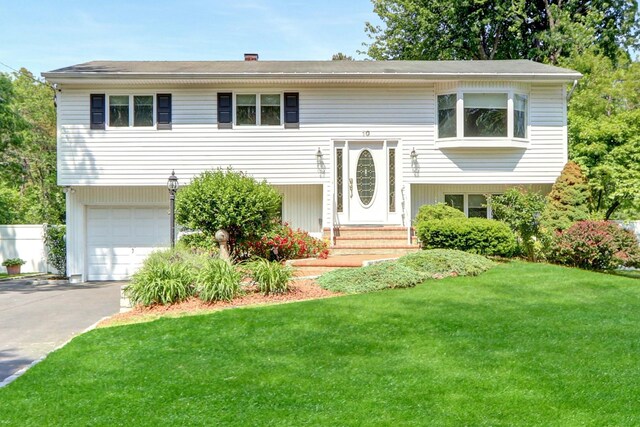 10 Charter Ct, Dix Hills, NY 11746 - raised ranch featuring an attached garage, asphalt driveway, and a front lawn