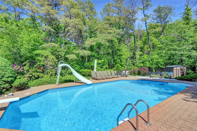 10 Charter Ct, Dix Hills, NY 11746 - view of swimming pool with a water slide, a diving board, and a patio