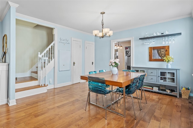 70-27 Olcott St, Forest Hills, NY 11375 - dining room with a chandelier, light wood-type flooring, stairs, and crown molding