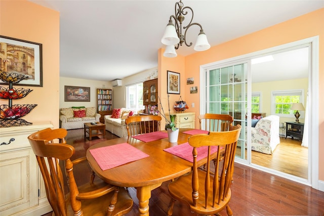 90 Fieldstone Blvd, Wappingers Falls, NY 12590 - dining area with dark wood finished floors, a chandelier, and an AC wall unit