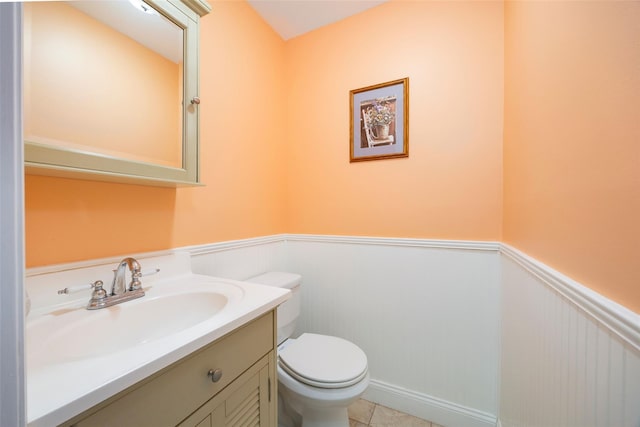 90 Fieldstone Blvd, Wappingers Falls, NY 12590 - half bath with wainscoting, toilet, vanity, and tile patterned floors