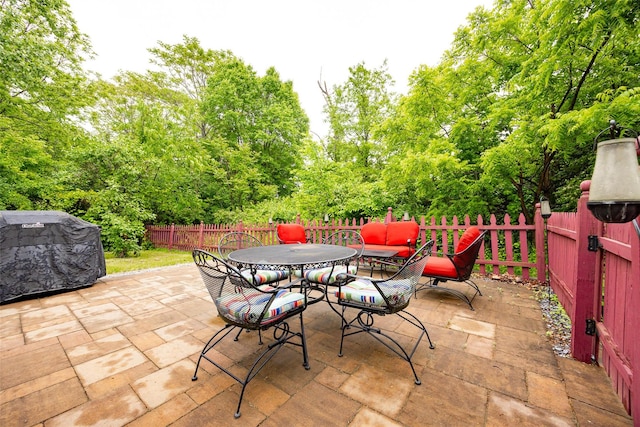 90 Fieldstone Blvd, Wappingers Falls, NY 12590 - fenced backyard with a patio area, outdoor dining space, view of scattered trees, and area for grilling