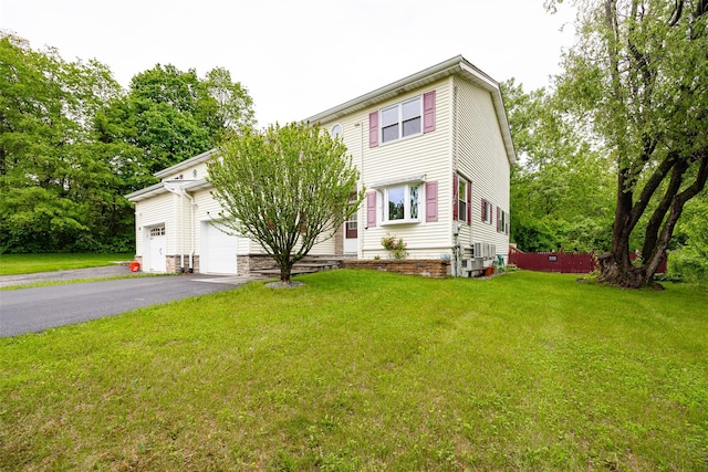 90 Fieldstone Blvd, Wappingers Falls, NY 12590 - view of front of property featuring asphalt driveway, a front lawn, and a garage