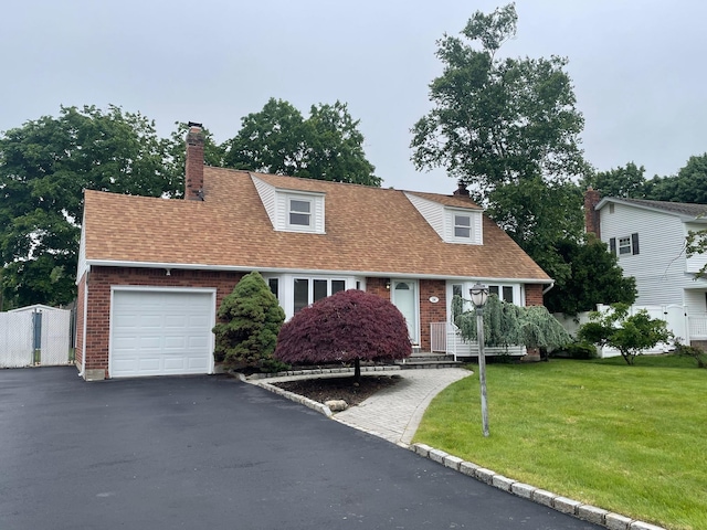 24 Gaymor Ln, Commack, NY 11725 - new england style home featuring brick siding, a garage, driveway, and a front yard