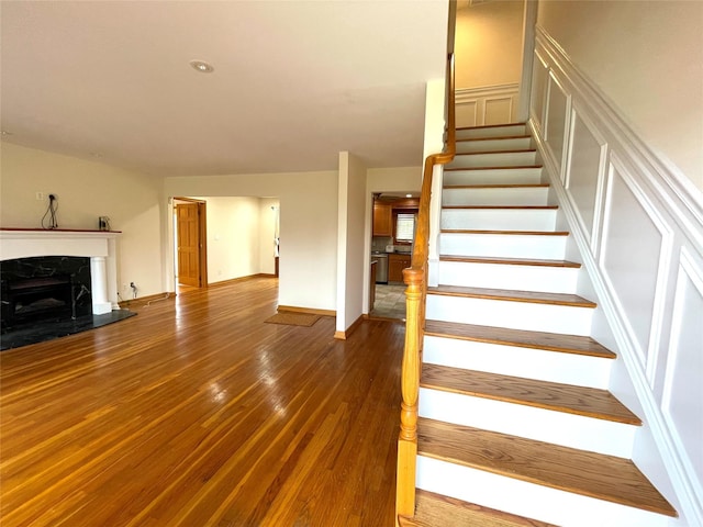 24 Gaymor Ln, Commack, NY 11725 - stairway featuring hardwood / wood-style floors, a premium fireplace, and baseboards
