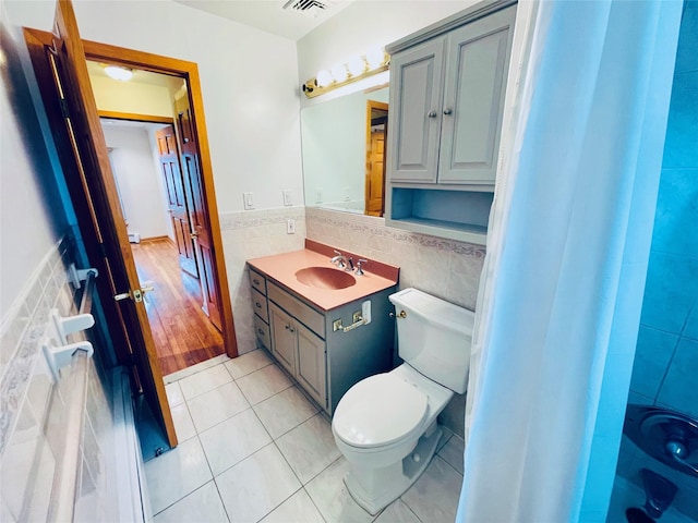 24 Gaymor Ln, Commack, NY 11725 - bathroom with tile walls, tile patterned floors, vanity, toilet, and wainscoting