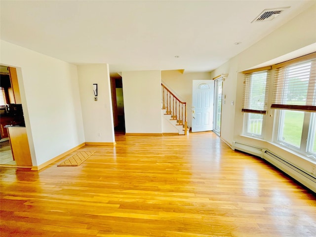 24 Gaymor Ln, Commack, NY 11725 - unfurnished living room featuring light wood-style flooring, healthy amount of natural light, and stairs