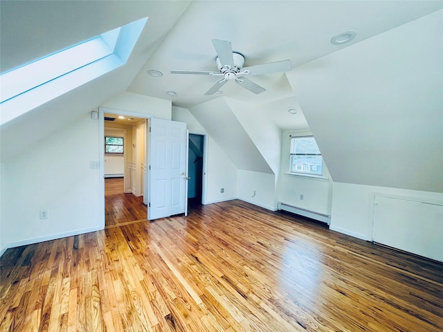 24 Gaymor Ln, Commack, NY 11725 - bonus room with baseboard heating, plenty of natural light, a skylight, wood finished floors, and vaulted ceiling
