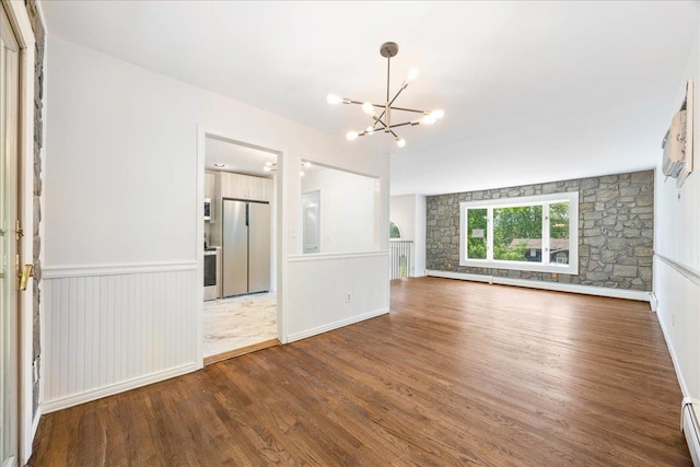 15 Mari Rd, Chester, NY 10918 - unfurnished living room featuring wood finished floors, a chandelier, a baseboard heating unit, and a wainscoted wall