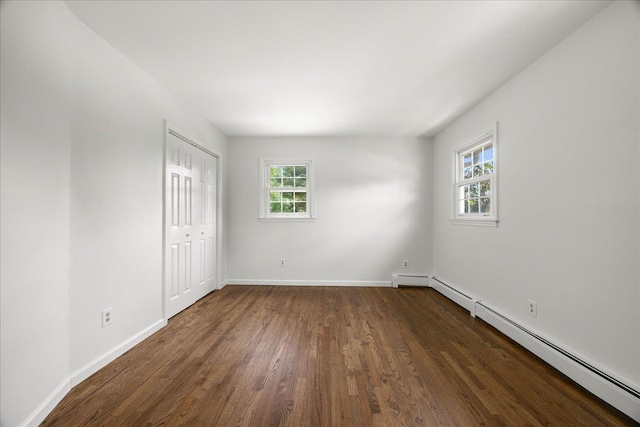 15 Mari Rd, Chester, NY 10918 - unfurnished bedroom with a baseboard radiator, dark wood-style floors, baseboards, and a closet