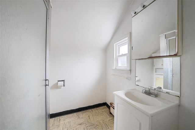 155 Carman Ave, East Rockaway, NY 11518 - bathroom featuring vaulted ceiling, vanity, baseboards, and baseboard heating