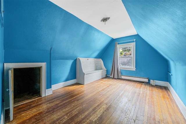 155 Carman Ave, East Rockaway, NY 11518 - bonus room with a baseboard radiator, hardwood / wood-style flooring, baseboards, and lofted ceiling