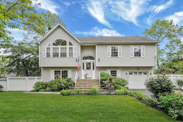 14 Arlington St, Patchogue, NY 11772 - split foyer home with an attached garage, driveway, and a chimney
