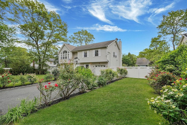 14 Arlington St, Patchogue, NY 11772 - back of house featuring a chimney and an attached garage