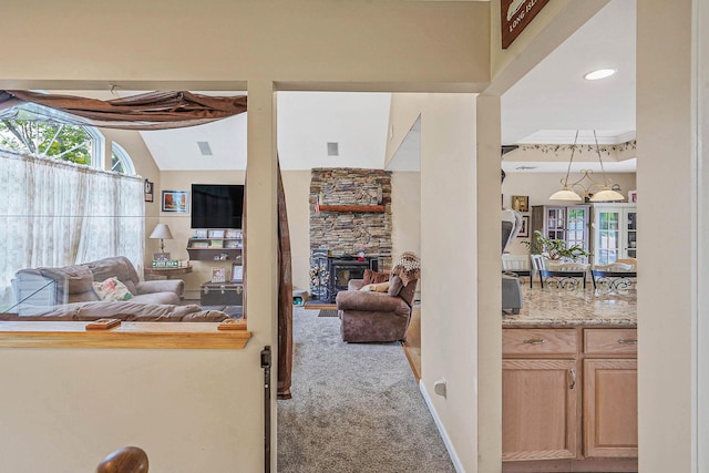 14 Arlington St, Patchogue, NY 11772 - living area with carpet flooring, a stone fireplace, and lofted ceiling
