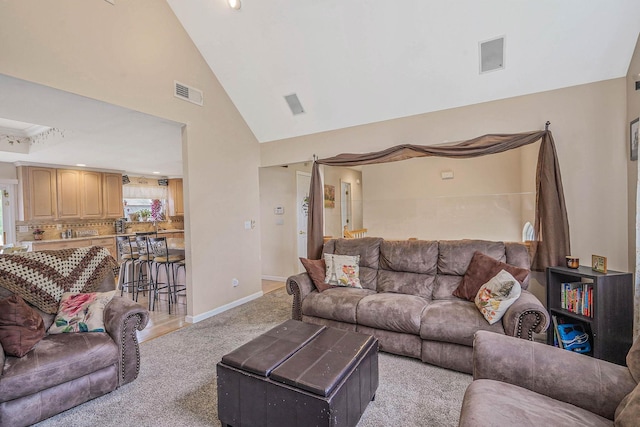 14 Arlington St, Patchogue, NY 11772 - living room with light carpet, baseboards, and high vaulted ceiling