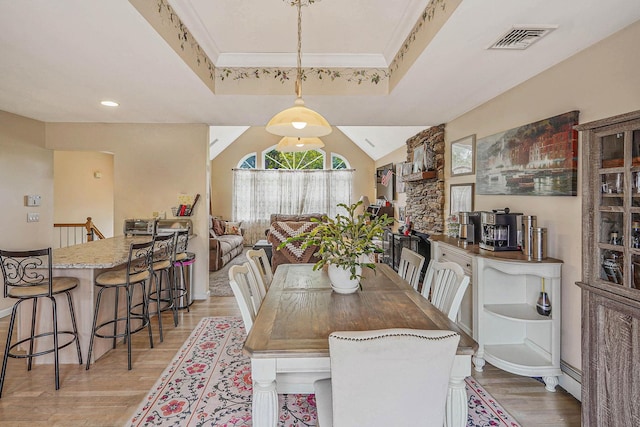 14 Arlington St, Patchogue, NY 11772 - dining area featuring light wood finished floors, a raised ceiling, and baseboards