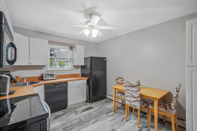 14 Arlington St, Patchogue, NY 11772 - kitchen with black appliances, a sink, ceiling fan, white cabinets, and light wood-style floors