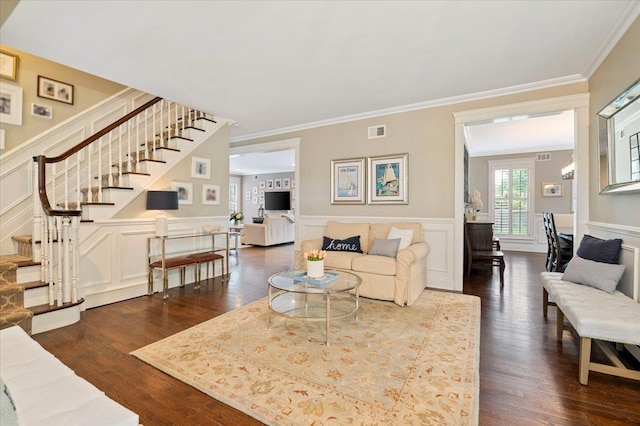 57 Harbor Park Dr, Centerport, NY 11721 - living area featuring stairway, a decorative wall, dark wood finished floors, crown molding, and a wainscoted wall