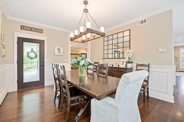 57 Harbor Park Dr, Centerport, NY 11721 - dining area featuring dark wood-type flooring, crown molding, a wainscoted wall, and a chandelier