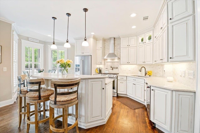 57 Harbor Park Dr, Centerport, NY 11721 - kitchen featuring high end appliances, wall chimney range hood, a sink, backsplash, and a kitchen island