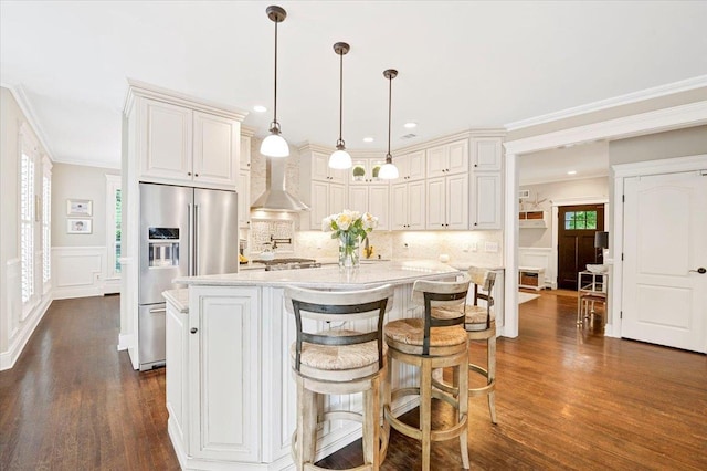 57 Harbor Park Dr, Centerport, NY 11721 - kitchen featuring high quality fridge, wall chimney range hood, a decorative wall, dark wood finished floors, and ornamental molding