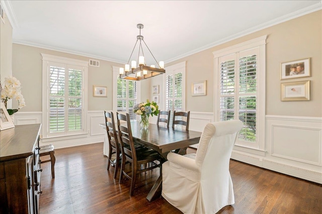 57 Harbor Park Dr, Centerport, NY 11721 - dining room with a chandelier, crown molding, dark wood-type flooring, wainscoting, and a decorative wall