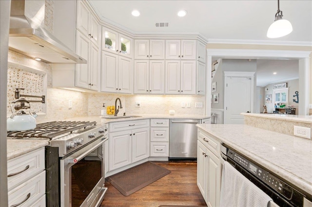 57 Harbor Park Dr, Centerport, NY 11721 - kitchen featuring appliances with stainless steel finishes, wall chimney range hood, a sink, dark wood-style flooring, and white cabinetry