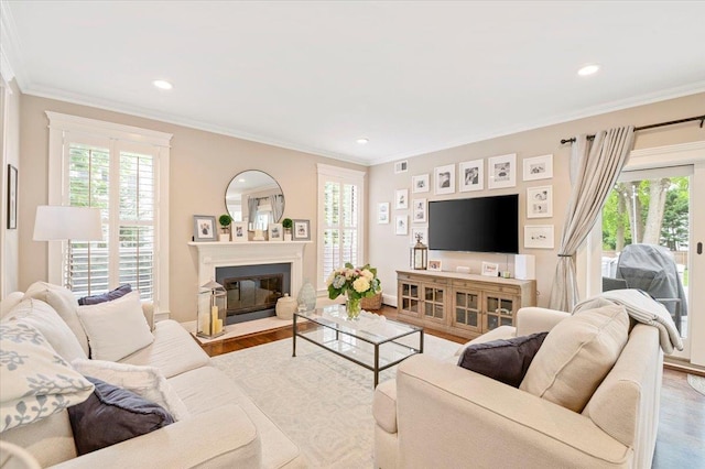 57 Harbor Park Dr, Centerport, NY 11721 - living area featuring healthy amount of natural light, baseboards, wood finished floors, recessed lighting, and crown molding