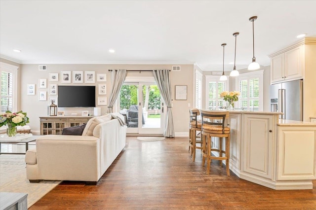 57 Harbor Park Dr, Centerport, NY 11721 - living room with plenty of natural light, dark wood finished floors, baseboards, crown molding, and recessed lighting