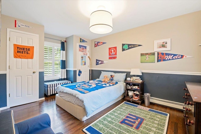 57 Harbor Park Dr, Centerport, NY 11721 - bedroom featuring a baseboard heating unit, wood finished floors, and baseboards