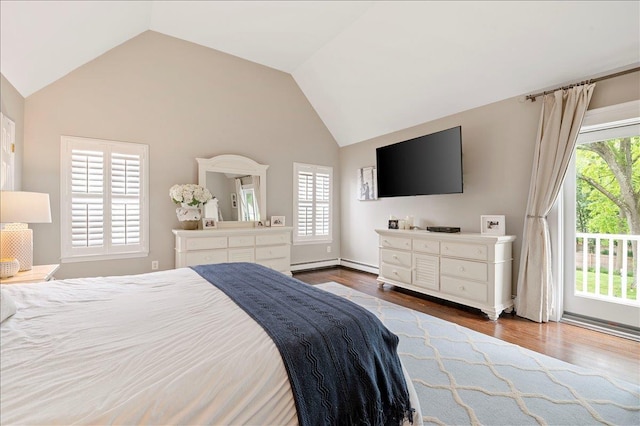 57 Harbor Park Dr, Centerport, NY 11721 - bedroom featuring multiple windows, vaulted ceiling, dark wood-type flooring, and baseboard heating
