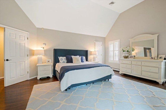 57 Harbor Park Dr, Centerport, NY 11721 - bedroom with vaulted ceiling, wood finished floors, a baseboard heating unit, and baseboards