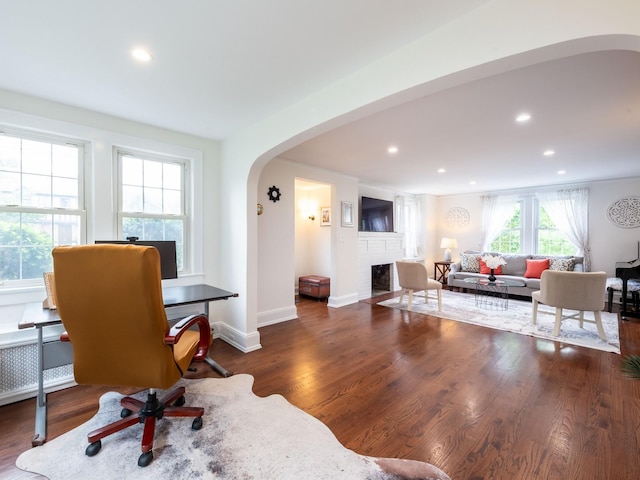 62 Webster Ave, Manhasset, NY 11030 - home office with arched walkways, a brick fireplace, wood finished floors, and recessed lighting