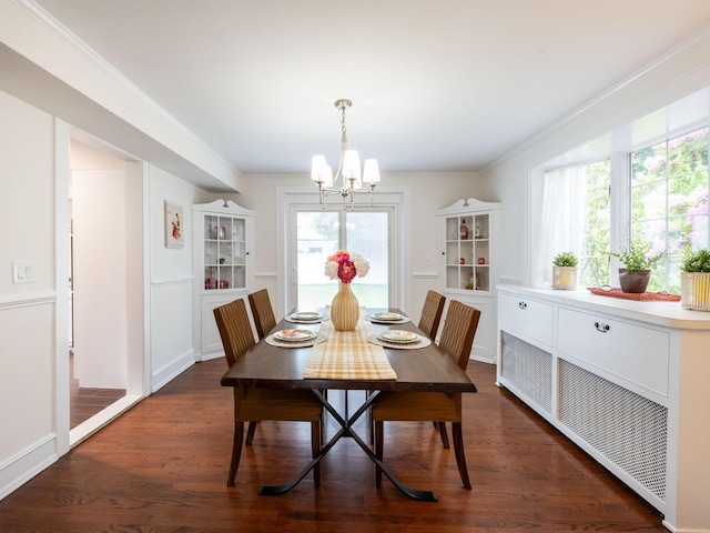 62 Webster Ave, Manhasset, NY 11030 - dining space with a chandelier, dark wood-style flooring, healthy amount of natural light, and ornamental molding