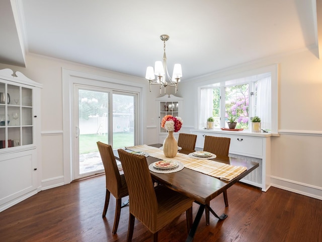 62 Webster Ave, Manhasset, NY 11030 - dining space with a chandelier, crown molding, dark wood-style flooring, and healthy amount of natural light