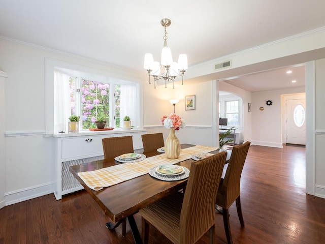 62 Webster Ave, Manhasset, NY 11030 - dining space featuring a chandelier, arched walkways, radiator heating unit, wood finished floors, and crown molding