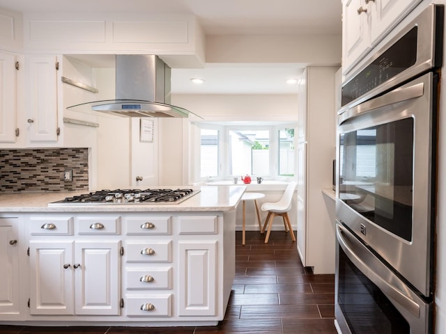62 Webster Ave, Manhasset, NY 11030 - kitchen with range hood, stainless steel gas stovetop, white cabinets, decorative backsplash, and dark wood-style floors