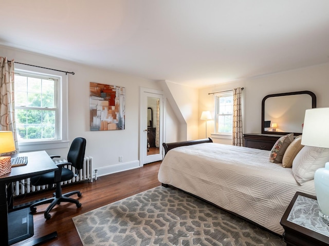 62 Webster Ave, Manhasset, NY 11030 - bedroom with wood finished floors, radiator, and an office area