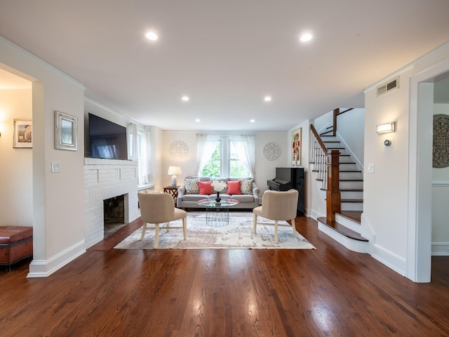 62 Webster Ave, Manhasset, NY 11030 - living room featuring stairs, a brick fireplace, ornamental molding, wood finished floors, and recessed lighting