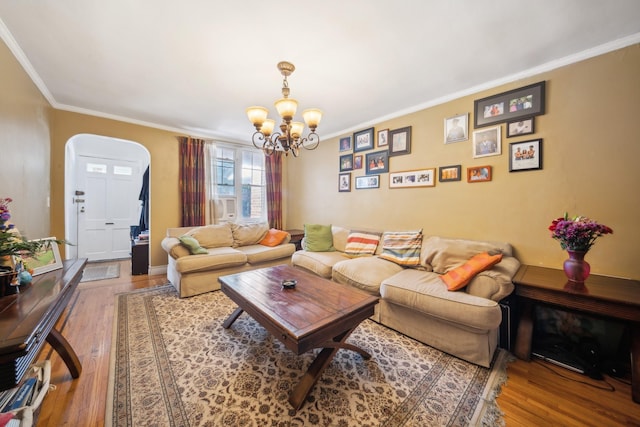 1304 Waring Ave, Bronx, NY 10469 - living room featuring arched walkways, a chandelier, wood finished floors, and ornamental molding
