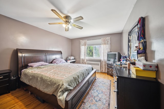 1304 Waring Ave, Bronx, NY 10469 - bedroom featuring radiator, light wood-style flooring, and ceiling fan