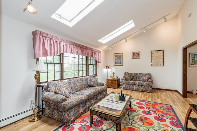 32 Lower Cross, Shoreham, NY 11786 - living room with rail lighting, a skylight, vaulted ceiling, wood finished floors, and a baseboard radiator