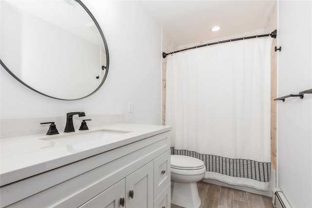 32 Lower Cross, Shoreham, NY 11786 - full bathroom with a baseboard radiator, vanity, toilet, wood finished floors, and shower / tub combo