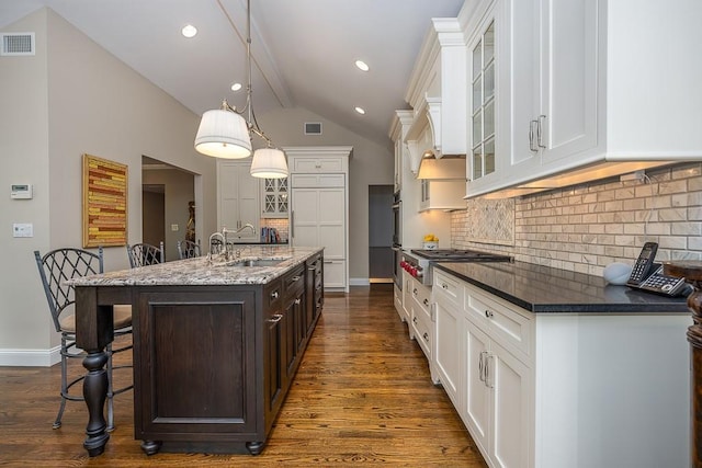 211 N Little Tor Rd, New City, NY 10956 - kitchen with stainless steel appliances, a sink, dark brown cabinetry, a breakfast bar, and a center island with sink