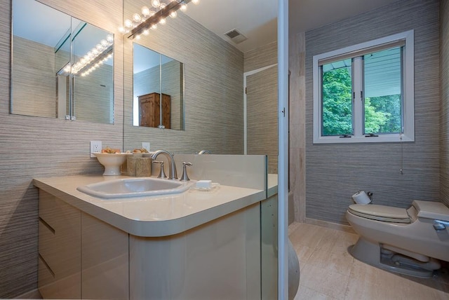 211 N Little Tor Rd, New City, NY 10956 - bathroom with vanity, toilet, tile walls, and tile patterned flooring