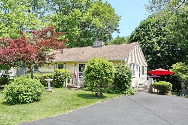 173 Massachusetts Ave, Congers, NY 10920 - view of front of house with a chimney, a front lawn, and a shingled roof