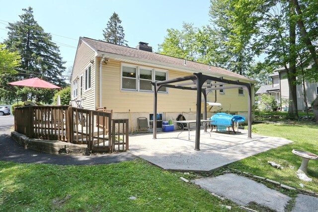 173 Massachusetts Ave, Congers, NY 10920 - rear view of property featuring a patio area, a chimney, a yard, and a deck