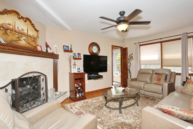 173 Massachusetts Ave, Congers, NY 10920 - living area featuring wood finished floors, a ceiling fan, a tiled fireplace, and baseboards