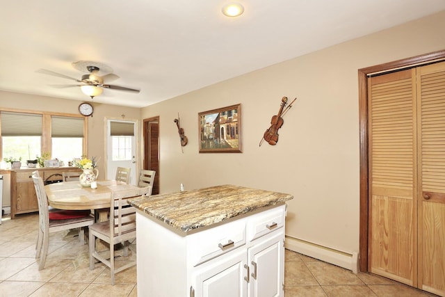 173 Massachusetts Ave, Congers, NY 10920 - kitchen featuring baseboard heating, light tile patterned floors, ceiling fan, white cabinets, and a center island